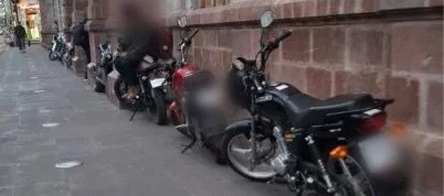 Espacios públicos de Ambato convertidos en parqueaderos.